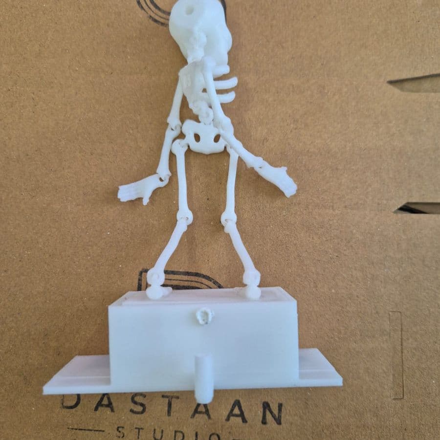 Dancing skeleton aquarium ornament on its Dastaan stand