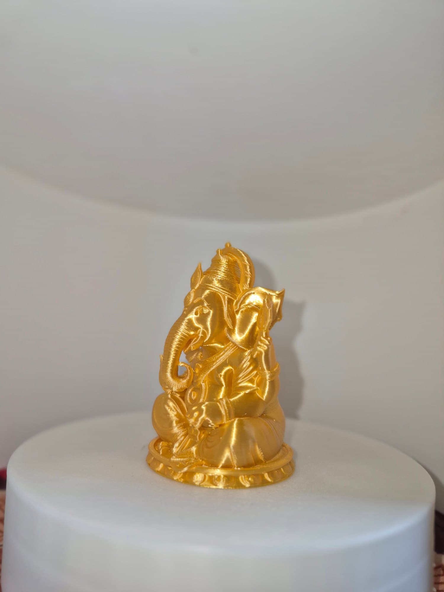 Ganesha Idol In Gold — lit vs unlit view